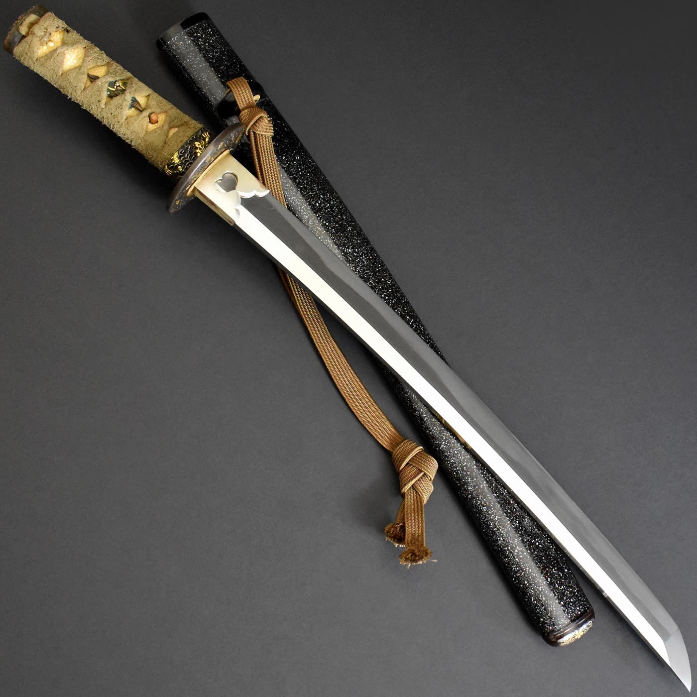 Sadanori wakizashi mounted and drawn beside its black lacquered saya